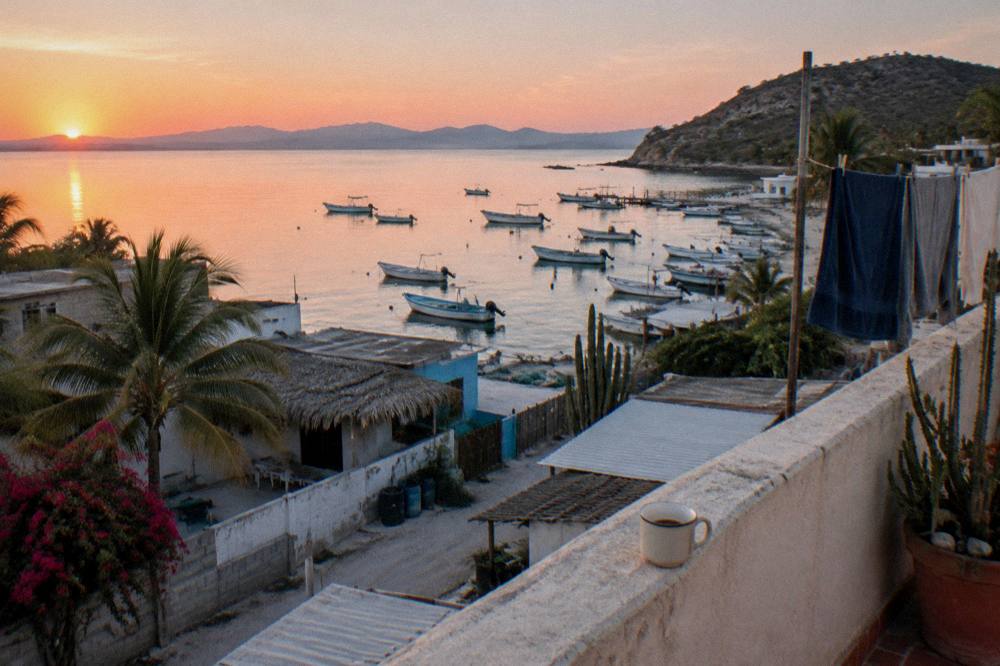 Sunrise over the La Paz bay seen from the boardwalk with calm water